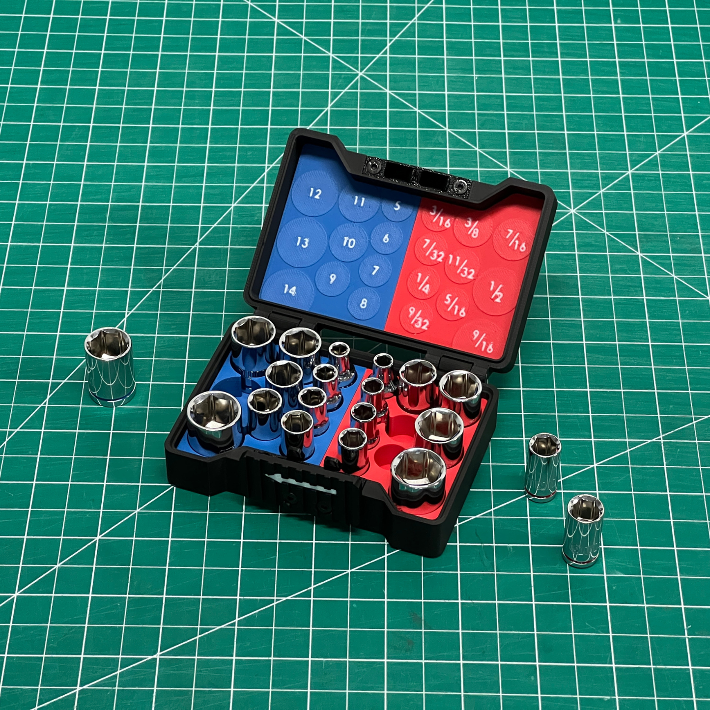 Set of socket wrenches in an open black case on a green grid background