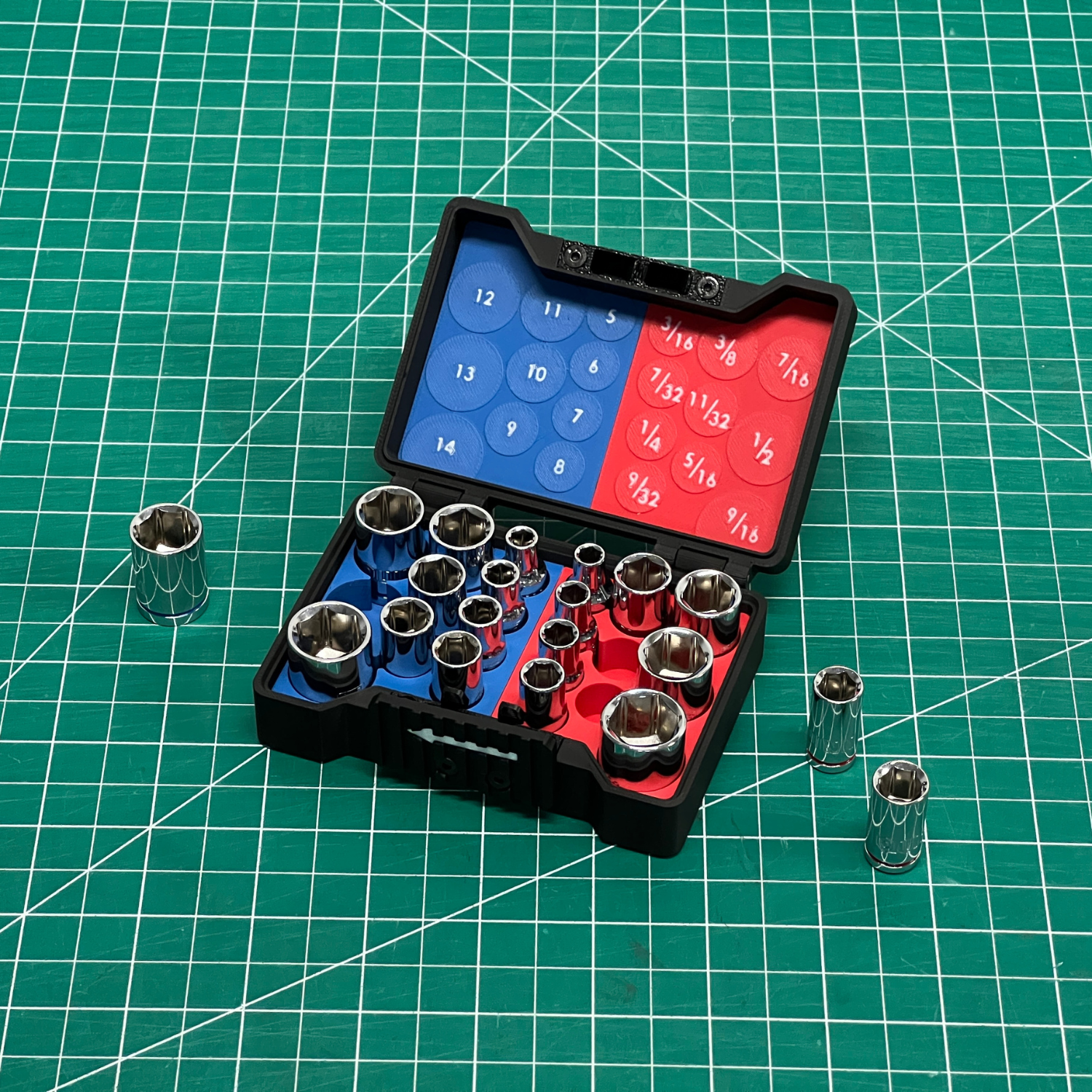 Set of socket wrenches in an open black case on a green grid background